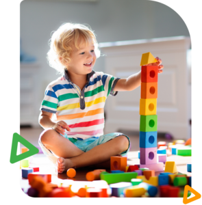 Toddler playing with colorful building blocks